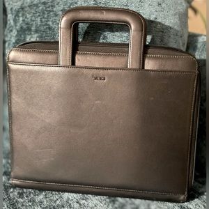 Tumi briefcase in black leather.